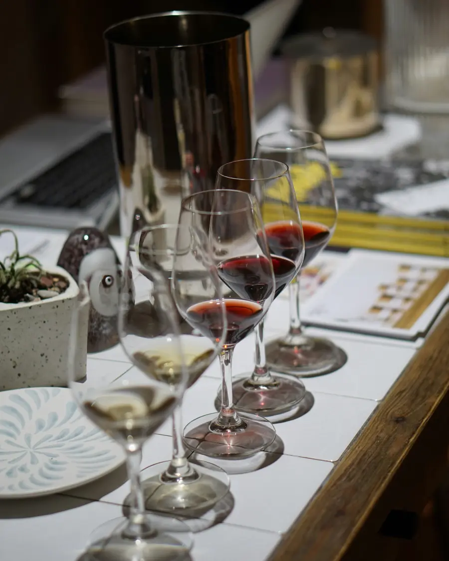 A home tasting flight set out on a table beside an ice bucket.